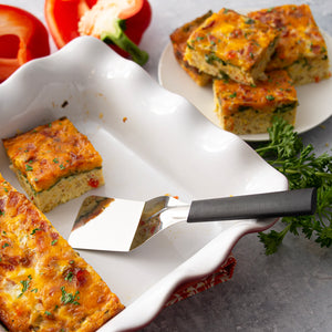 Black handle Mini Server in a pan of egg bake made with eggs, cheese, spinach, peppers and more!
