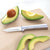 Rada Cutlery Peeling Paring knife with silver handle with sliced avocado.