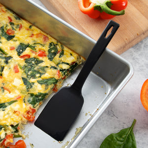 Serving a pan of feta and spinach quiche with the one-piece nylon potluck spatula. 