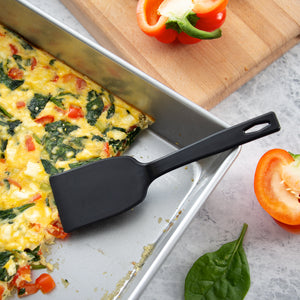 A small Rada Cutlery potluck spatula serving a pan of spinach and Feta egg bake. 