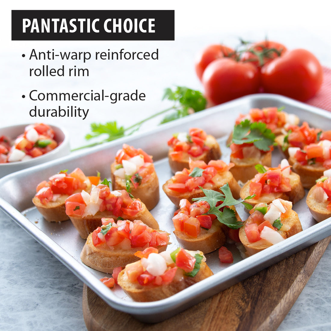 Quarter Sheet Pan filled with bruschetta on cutting board with tomatoes and basil.