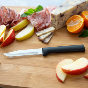 Rada Cutlery Serrated Regular Paring Knife with black handle on cutting board with snacks. 