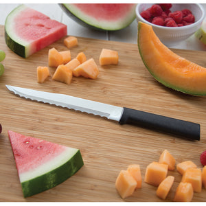 Serrated Slicer with black handle with berries and melon on wooden cutting board. 