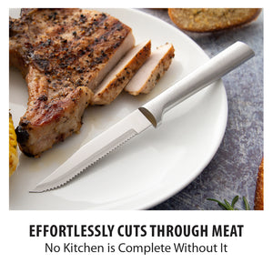 Serrated steak knife on a plate slicing a pork chop. Effortlessly cuts through meat. No kitchen is complete without it. 