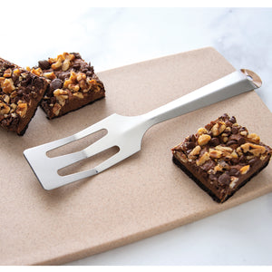 Serverspoon spatula shown on cutting board with brownies. 