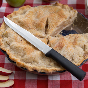 Slicer knife with black handle resting on an apple pie