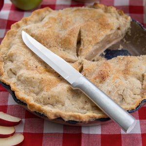 Stubby Butcher Knife with silver handle on apple pie. 
