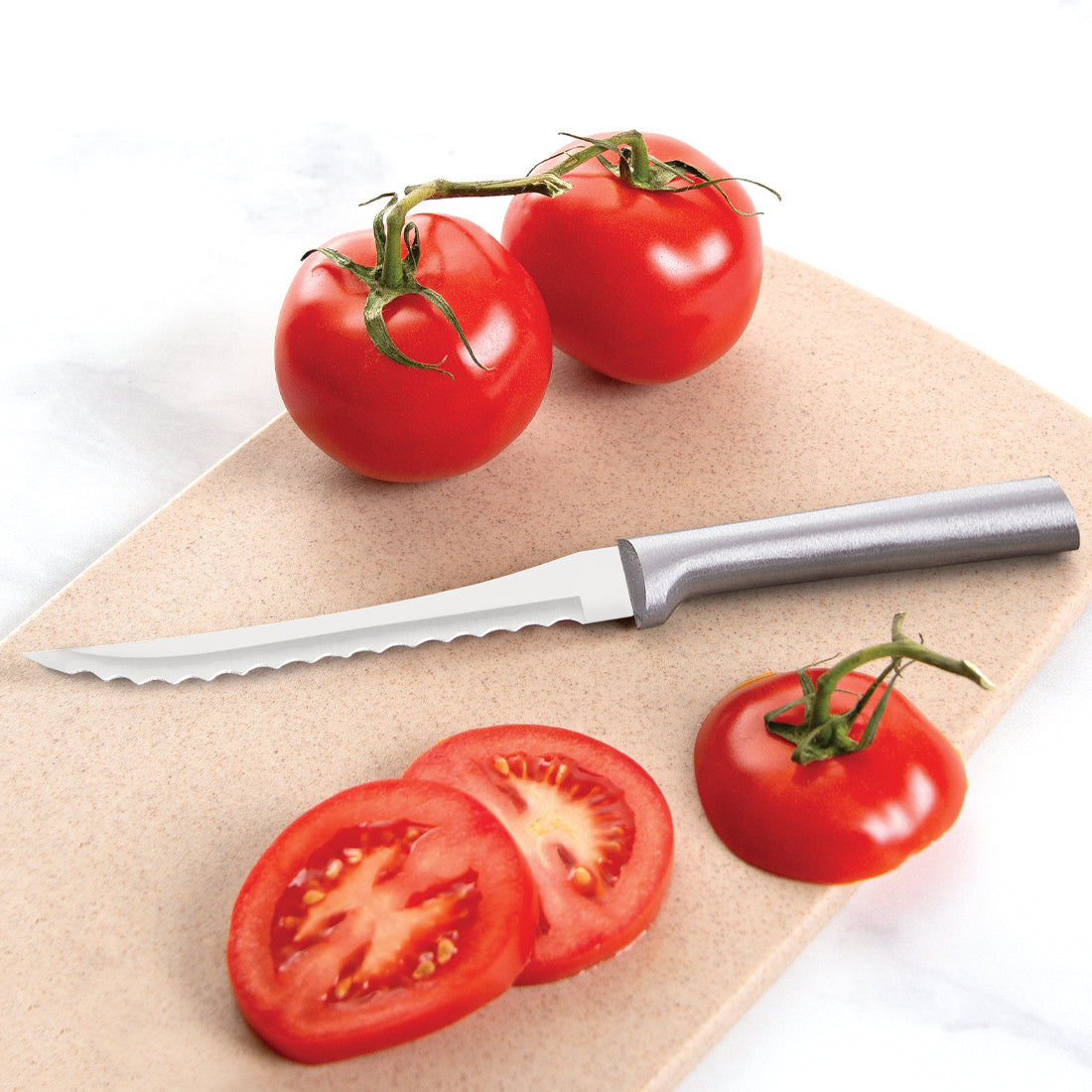 Rada Cutlery Tomato Slicer knife with silver handle and sliced tomatoes on cutting board.