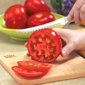 Tomato Slicer knife with silver handle in use slicing tomatoes. 