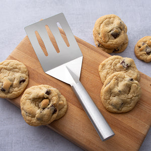 Silver handle Turnover with chocolate chip cookies on a cutting board.